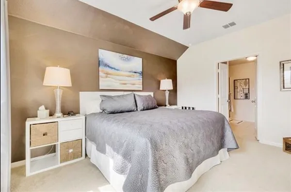 a spacious bedroom with a bed and a window