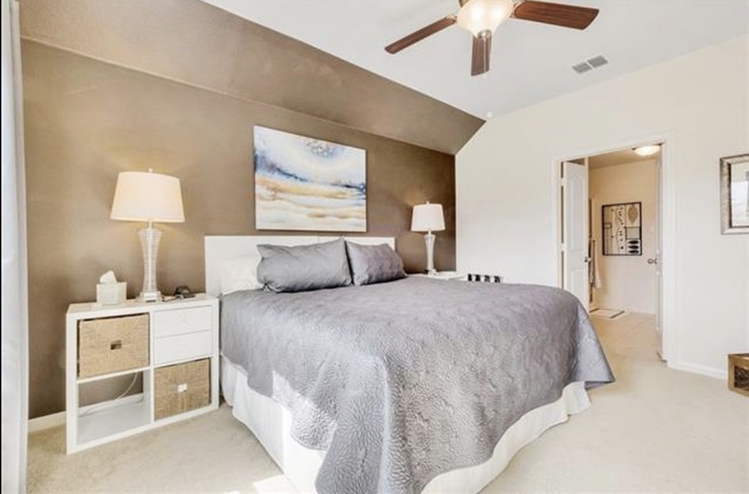 13405 Clara Martin Road Manor, TX 78653 - Photo 12 of 26 Bedroom with ceiling fan, carpet floors, and vaulted ceiling