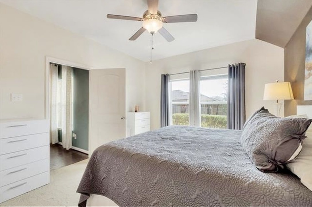 13405 Clara Martin Road Manor, TX 78653 - Photo 13 of 26 Bedroom featuring lofted ceiling, ceiling fan, and light carpet