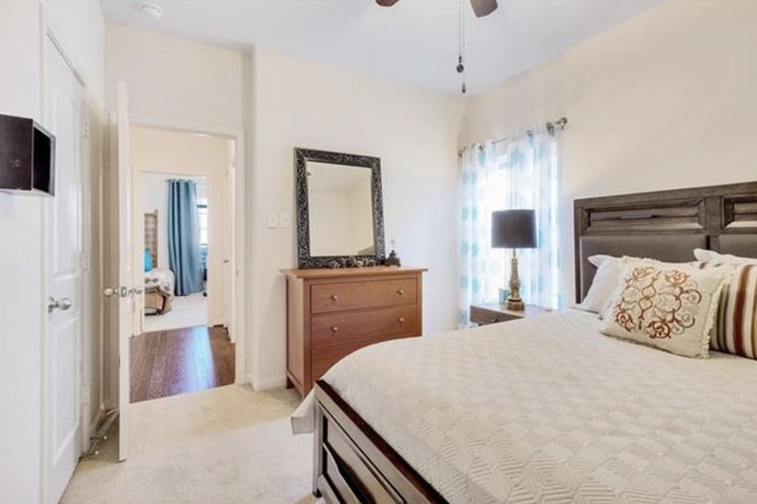 13405 Clara Martin Road Manor, TX 78653 - Photo 18 of 26 Bedroom with light colored carpet and a ceiling fan