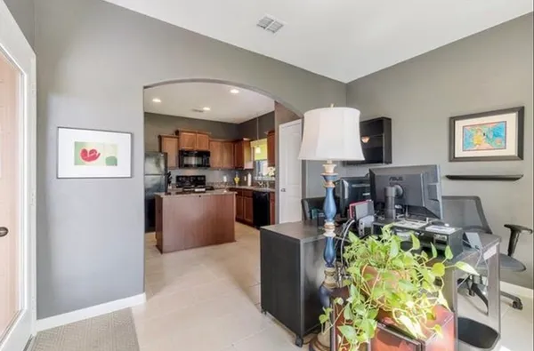 a living room with furniture and a kitchen