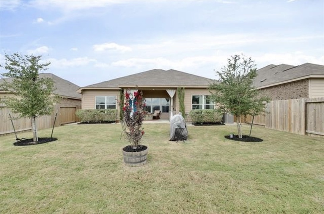 13405 Clara Martin Road Manor, TX 78653 - Photo 25 of 26 Back of house featuring a fenced backyard and a patio area
