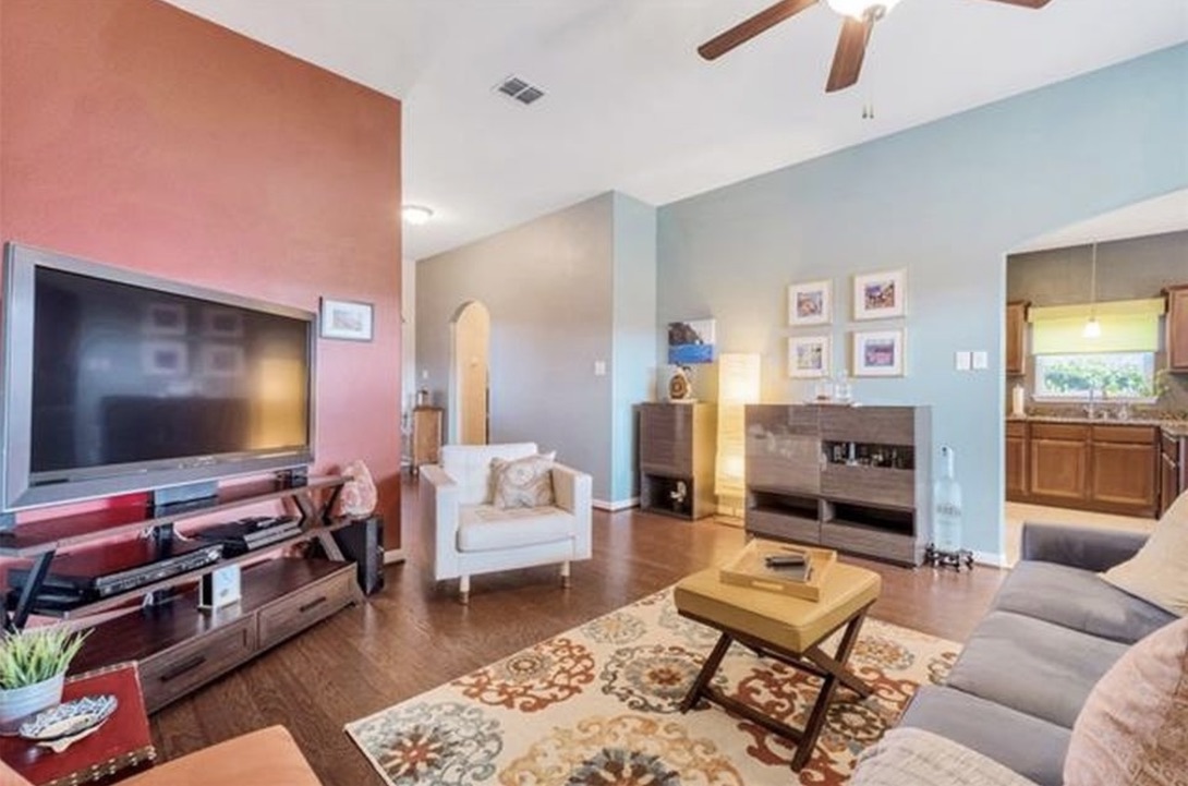 13405 Clara Martin Road Manor, TX 78653 - Photo 4 of 26 Living room featuring arched walkways, ceiling fan, and dark wood-style flooring