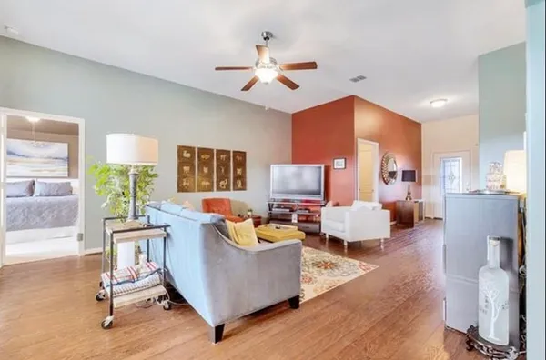 a living room with granite countertop furniture and a kitchen view