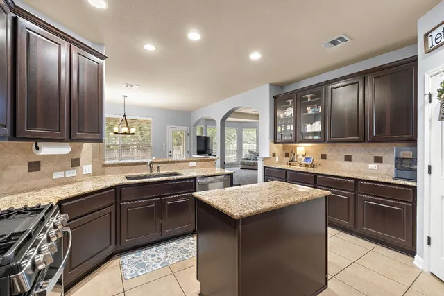 a kitchen with a sink stove and cabinets