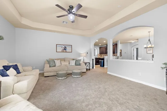 a living room with furniture and kitchen view