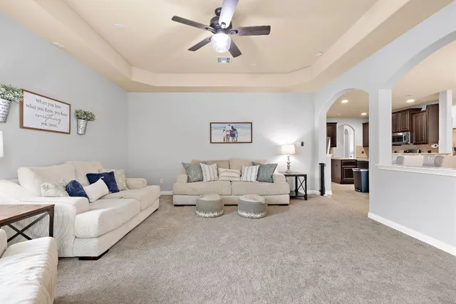 a living room with fireplace furniture and a chandelier
