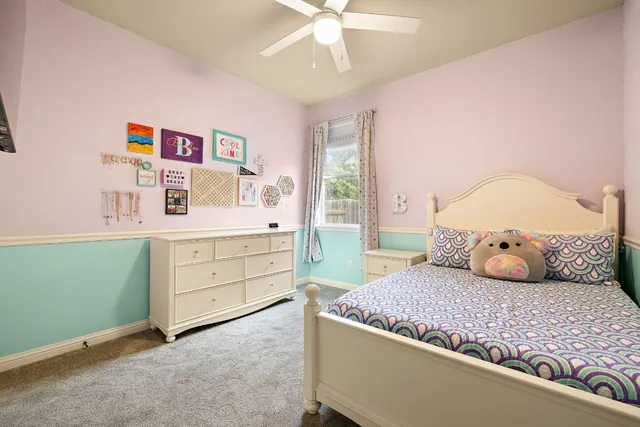 a bedroom with a bed and a dresser