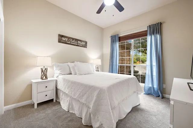 a spacious bedroom with a bed and a cabinets