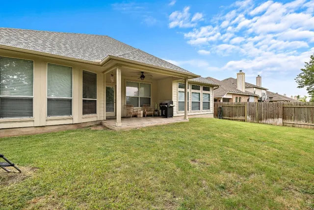 a view of a house with backyard porch and garden
