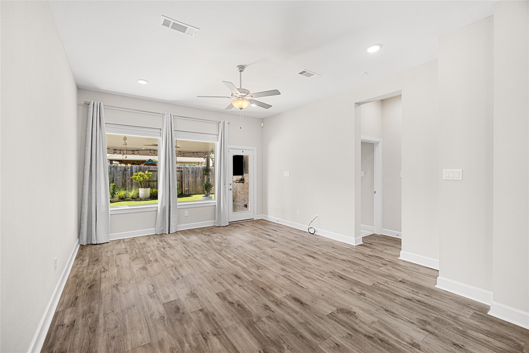 15611 Rising Wren Court Conroe, TX 77302 - Photo 11 of 41 Spacious living room and den area featuring abundant natural light and versatile layout options.