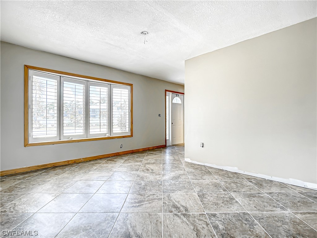 207 Redfish Road Fort Myers Beach, FL 33931 - Photo 13 of 50 a view of an empty room with a window