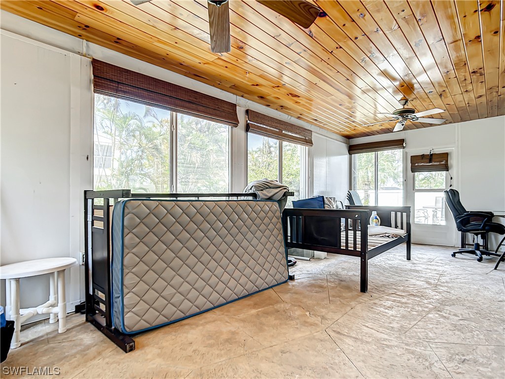 207 Redfish Road Fort Myers Beach, FL 33931 - Photo 18 of 50 a living room with a couch and a table