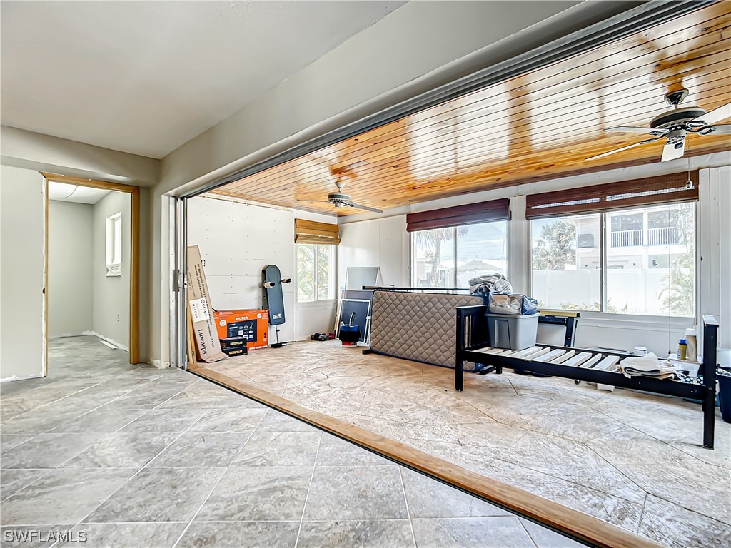 207 Redfish Road Fort Myers Beach, FL 33931 - Photo 20 of 50 a bedroom with furniture and large window