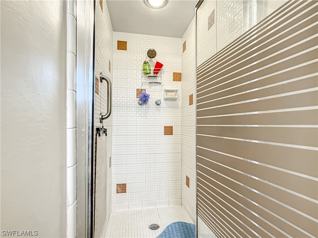 207 Redfish Road Fort Myers Beach, FL 33931 - Photo 26 of 50 a bathroom with a bathtub and a shower