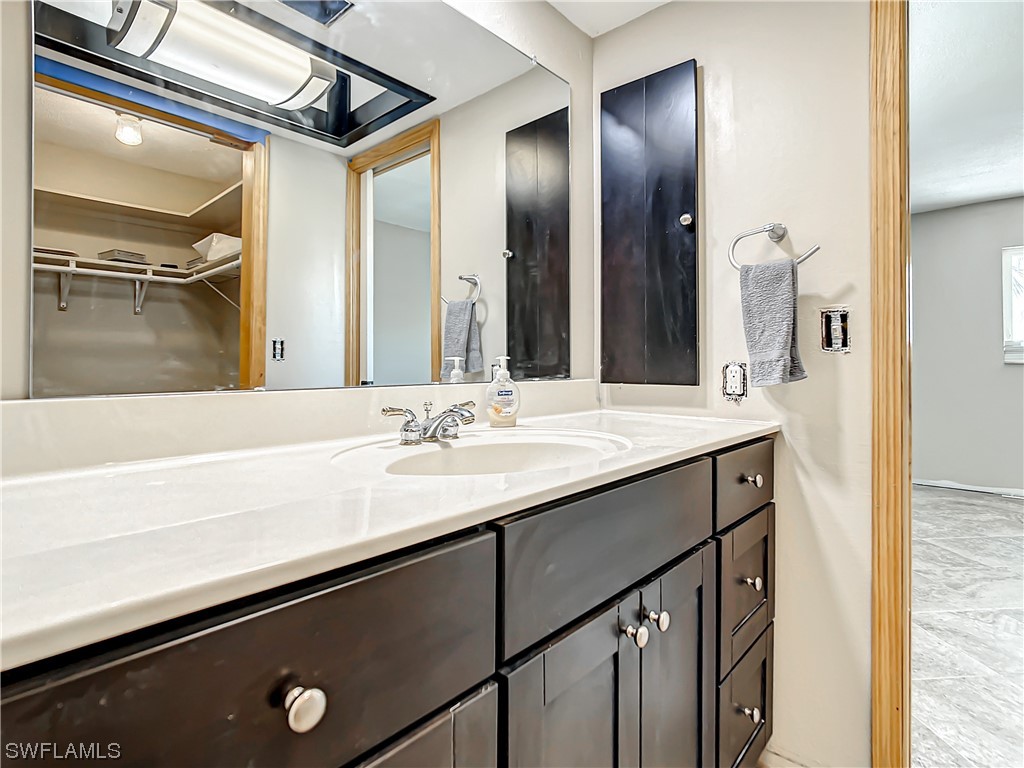207 Redfish Road Fort Myers Beach, FL 33931 - Photo 27 of 50 a bathroom with a sink and a mirror
