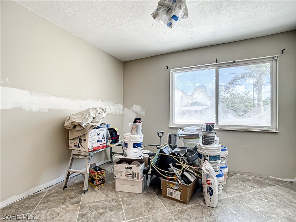 207 Redfish Road Fort Myers Beach, FL 33931 - Photo 30 of 50 a living room with furniture a window and gym equipment