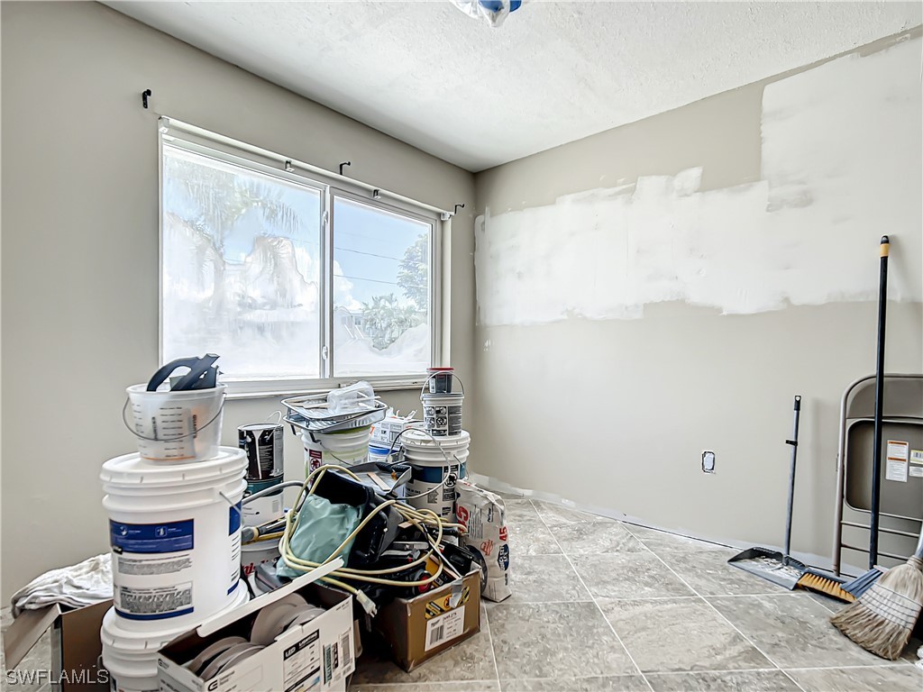 207 Redfish Road Fort Myers Beach, FL 33931 - Photo 31 of 50 a living room with furniture a rug and a large window