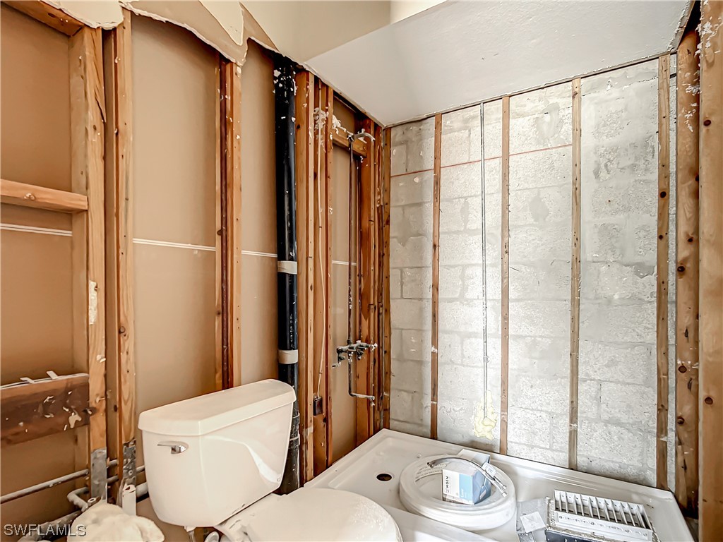 207 Redfish Road Fort Myers Beach, FL 33931 - Photo 33 of 50 a bathroom with a toilet a sink and a shower