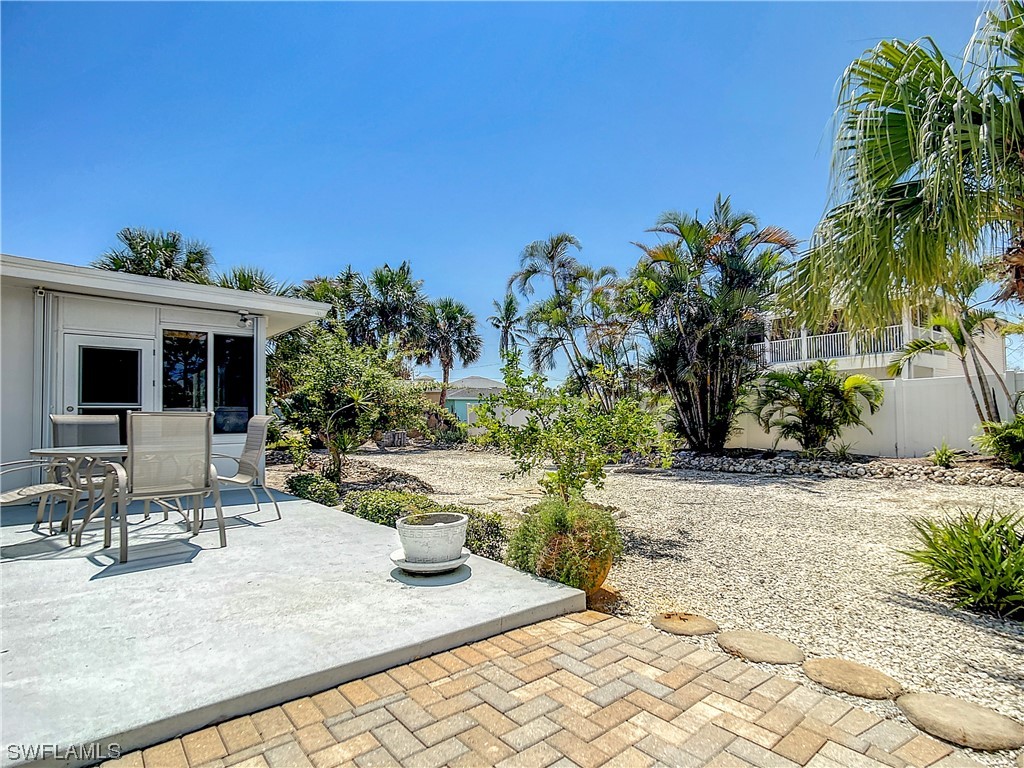 207 Redfish Road Fort Myers Beach, FL 33931 - Photo 39 of 50 a view of a backyard with plants and palm trees