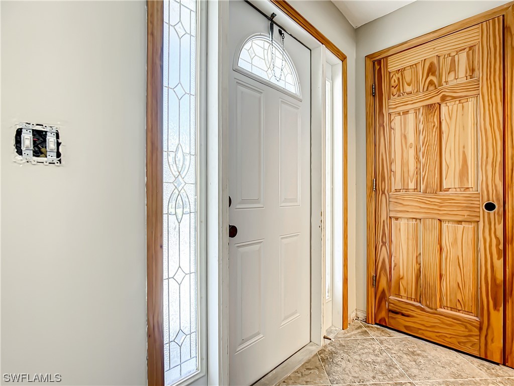207 Redfish Road Fort Myers Beach, FL 33931 - Photo 4 of 50 a view of front door with hallway