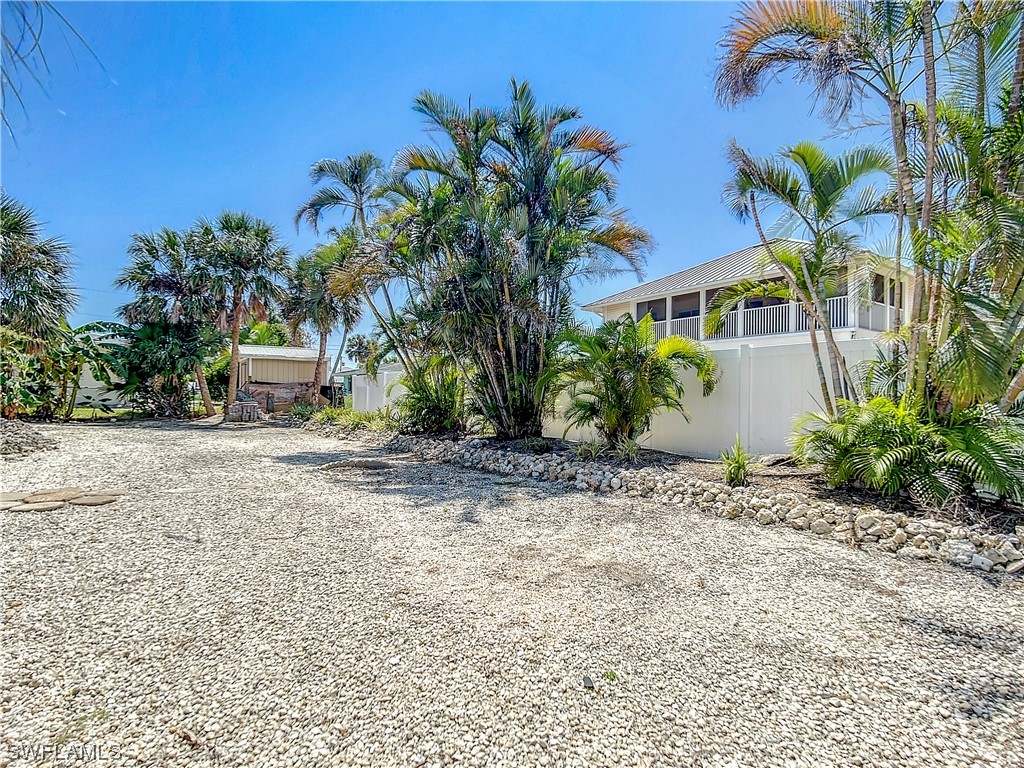 207 Redfish Road Fort Myers Beach, FL 33931 - Photo 43 of 50 a front view of a house with garden