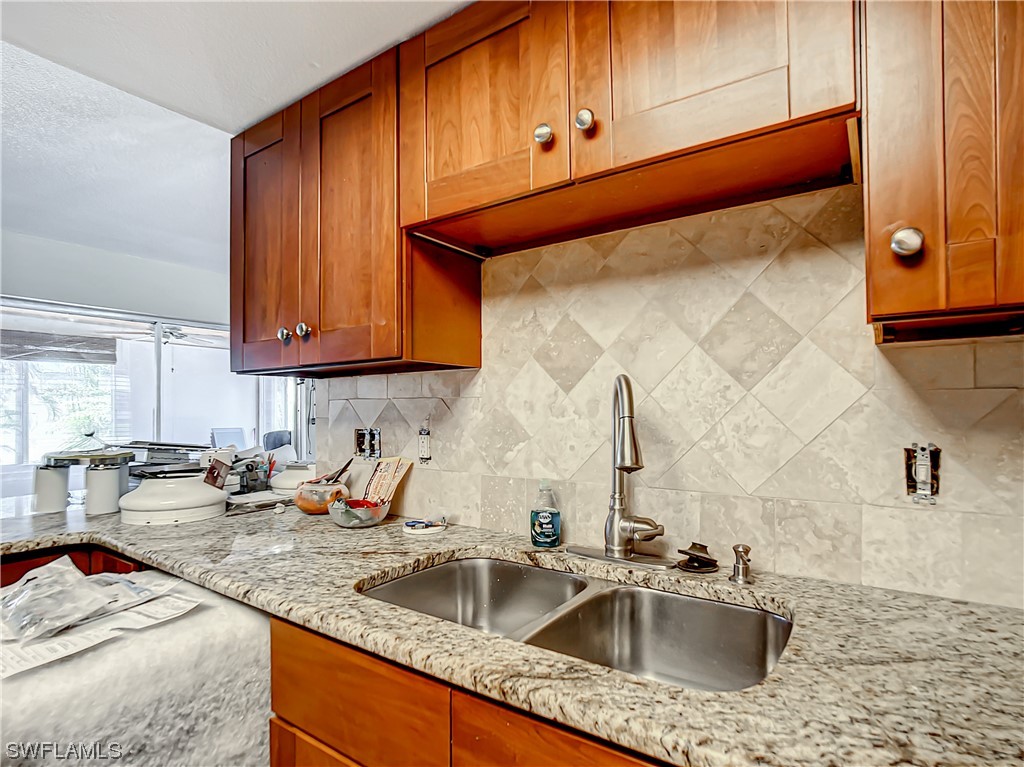 207 Redfish Road Fort Myers Beach, FL 33931 - Photo 6 of 50 a kitchen with stainless steel appliances granite countertop a sink and cabinets