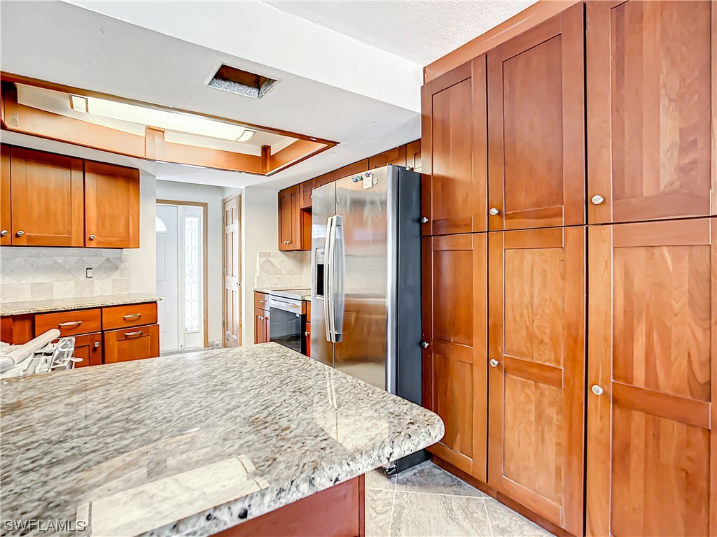 207 Redfish Road Fort Myers Beach, FL 33931 - Photo 9 of 50 a bedroom with a bed and a dresser