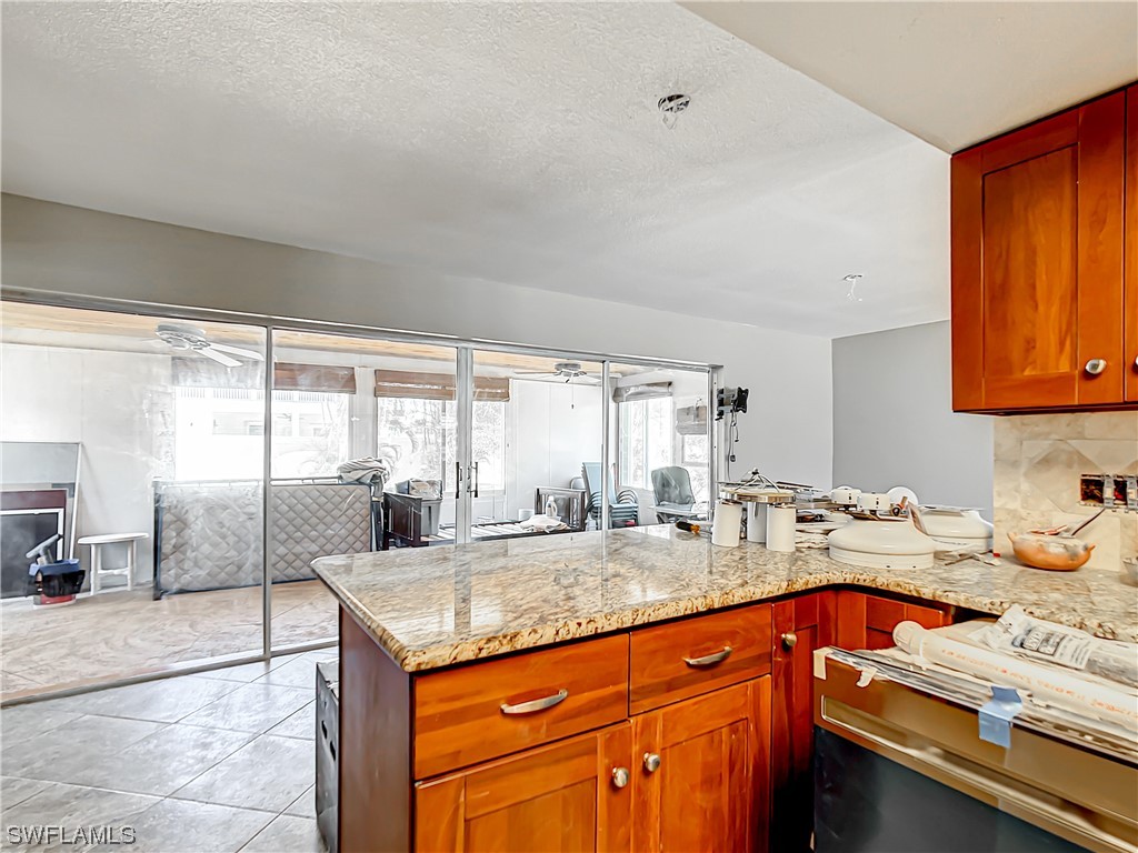 207 Redfish Road Fort Myers Beach, FL 33931 - Photo 10 of 50 a kitchen with a sink and a refrigerator