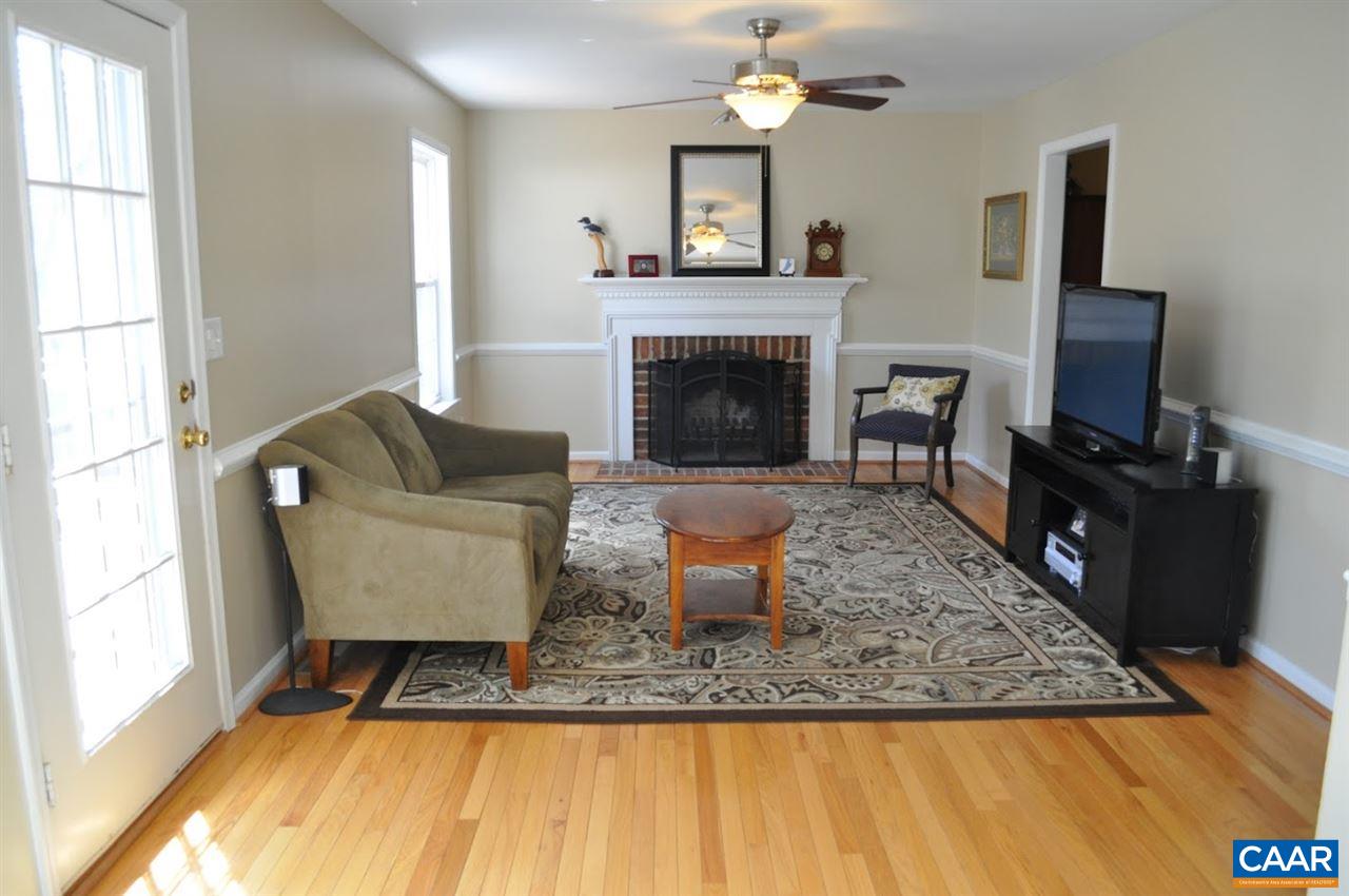 840 Harris Road Charlottesville, VA 22902 - Photo 2 of 11 a living room with furniture a fireplace and a flat screen tv