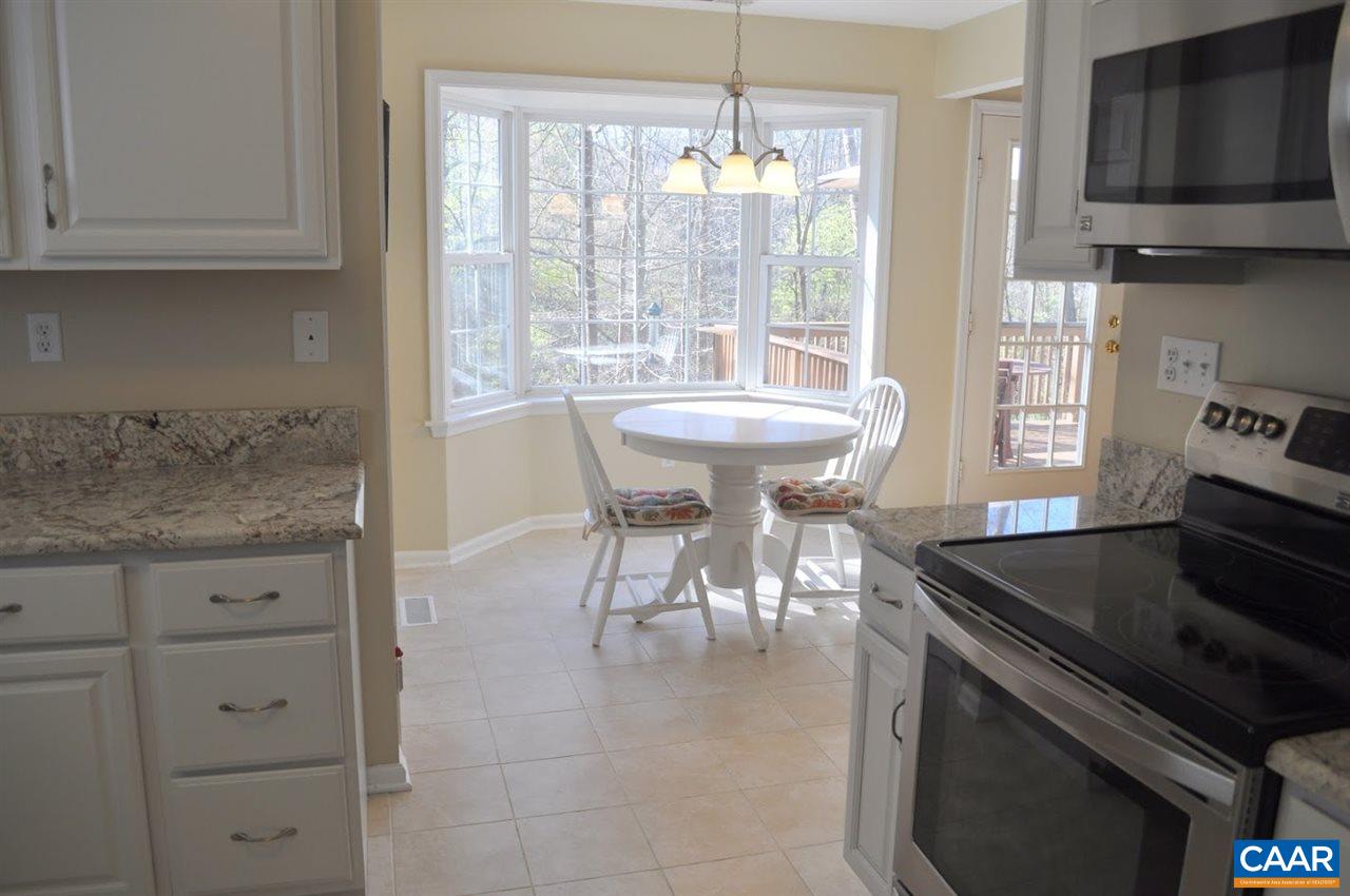 840 Harris Road Charlottesville, VA 22902 - Photo 8 of 11 a kitchen with stainless steel appliances granite countertop a stove a sink and a microwave
