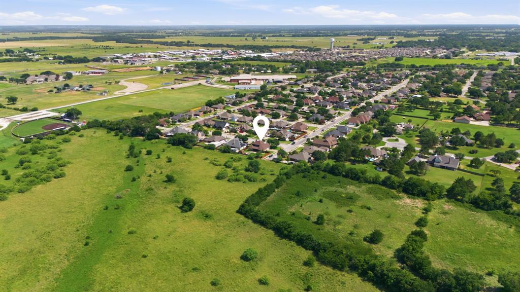 600 Aspen Street Pilot Point, TX 76258 - Photo 38 of 39 Aerial perspective showcasing a residential community surrounded by expansive green spaces