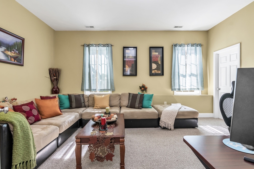 14 Tedesco Road Methuen, MA 01844 - Photo 21 of 40 a living room with furniture a large window and a flat screen tv