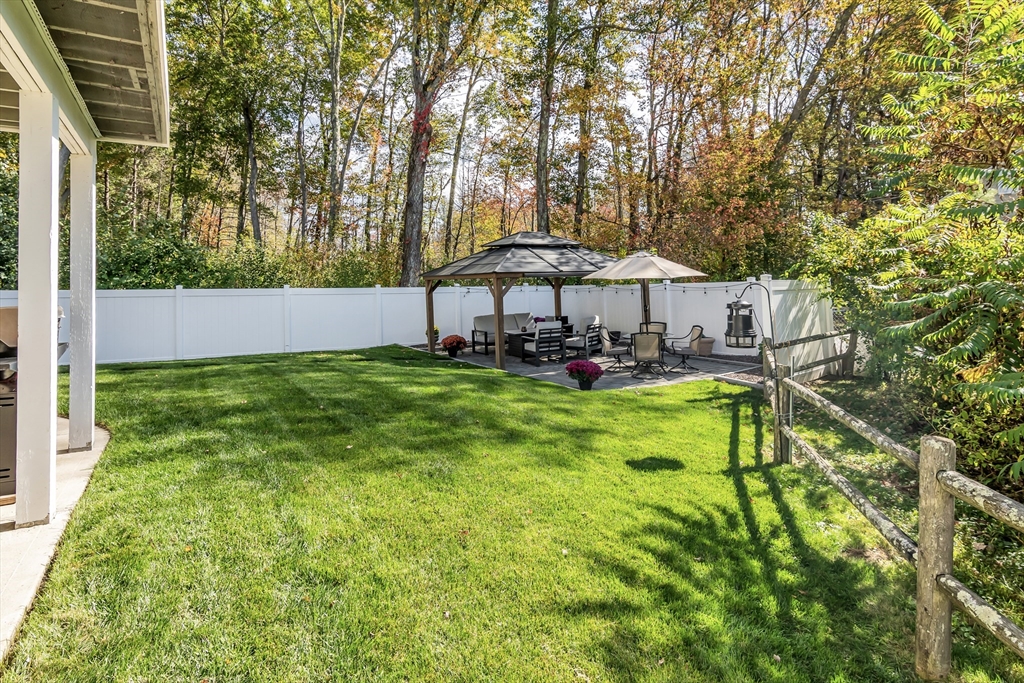 14 Tedesco Road Methuen, MA 01844 - Photo 29 of 40 a view of a house with a yard table and chairs under an umbrella