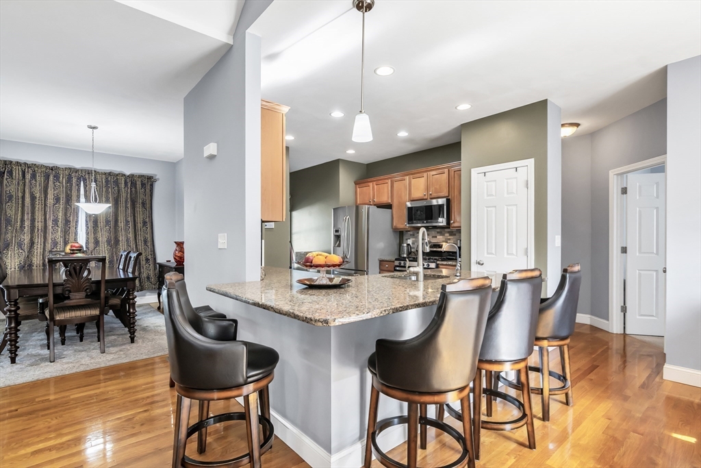 14 Tedesco Road Methuen, MA 01844 - Photo 8 of 40 a dining area with stainless steel appliances kitchen island granite countertop a dining table chairs and a refrigerator