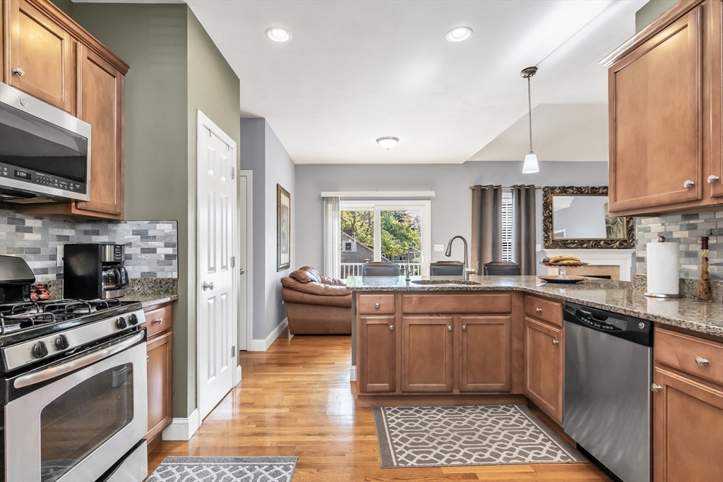14 Tedesco Road Methuen, MA 01844 - Photo 10 of 40 a kitchen with stainless steel appliances a stove sink microwave and cabinets