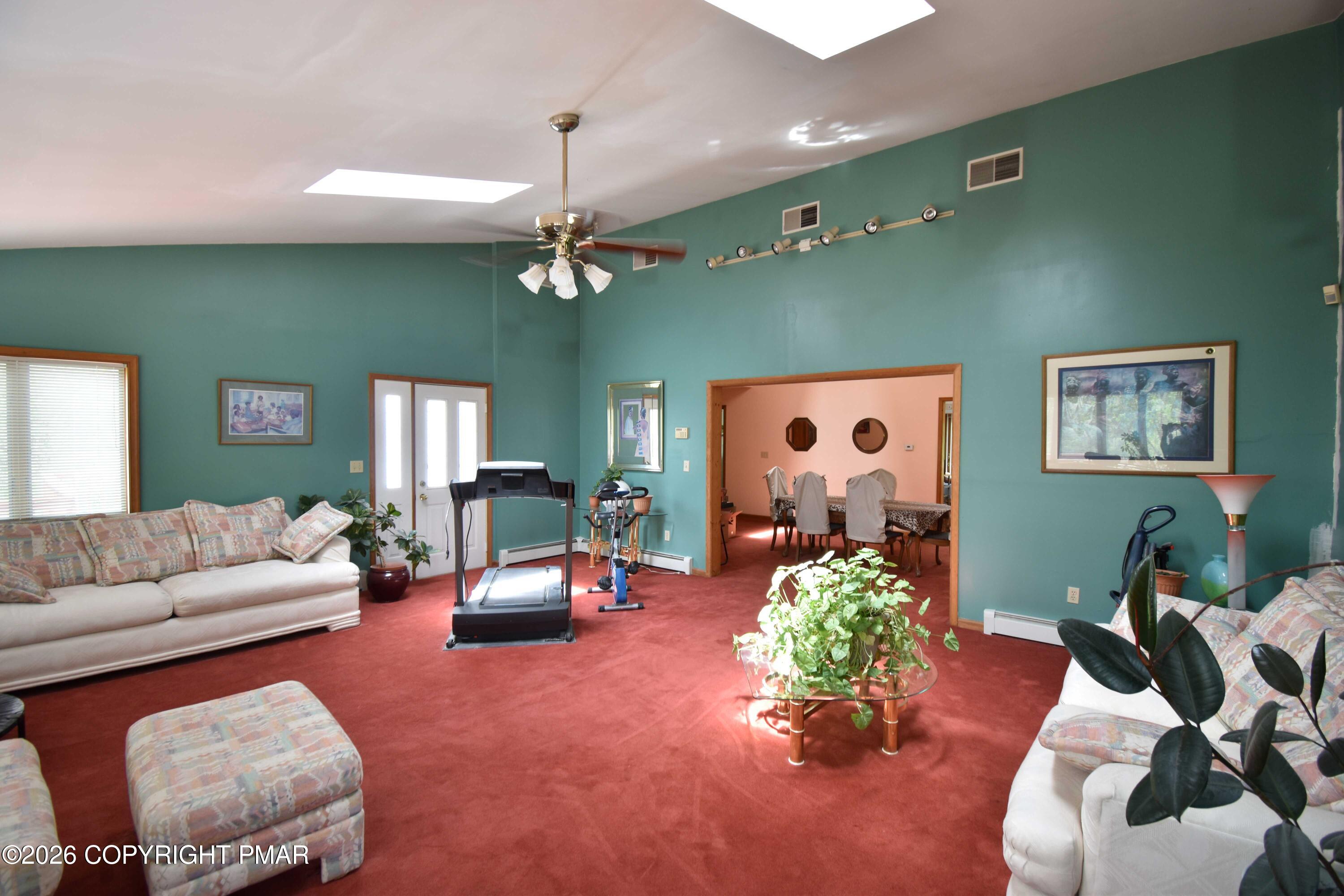 160 Quiet Valley Road Mount Bethel, PA 18343 - Photo 14 of 44 a living room with furniture and a chandelier
