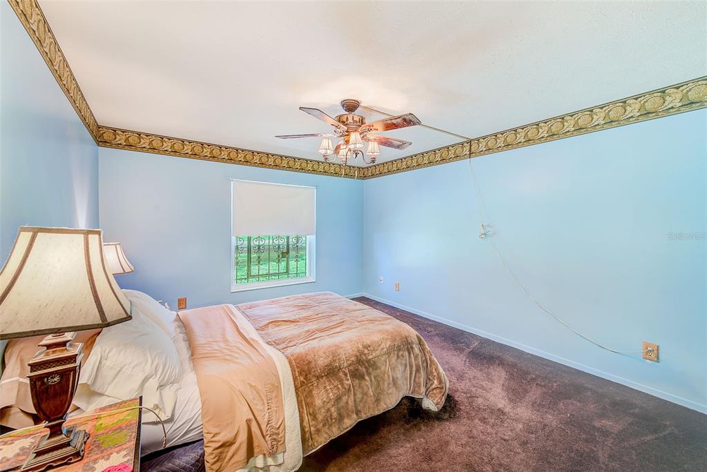 4707 East Temple Heights Road Tampa, FL 33617 - Photo 13 of 54 a bedroom with a bed and a window
