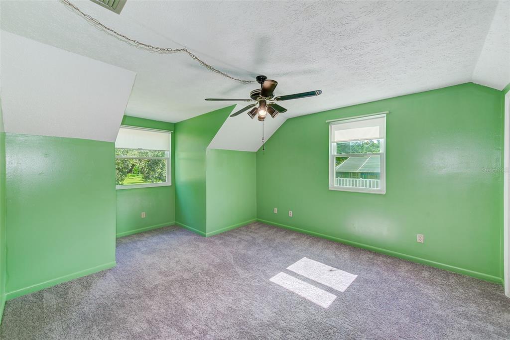 4707 East Temple Heights Road Tampa, FL 33617 - Photo 19 of 54 a view of a room with a fan and a window