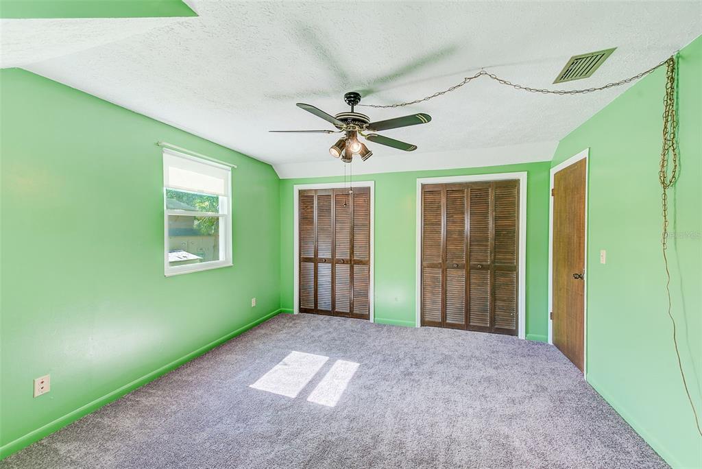 4707 East Temple Heights Road Tampa, FL 33617 - Photo 20 of 54 a view of a livingroom with a ceiling fan and window