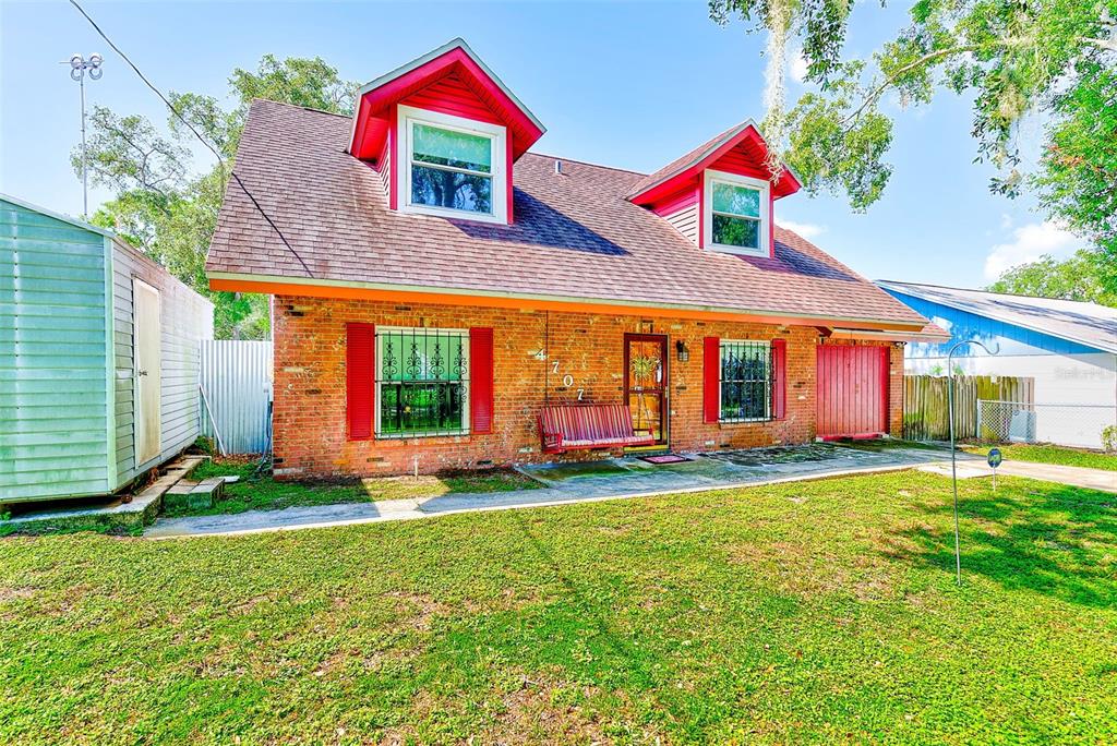 4707 East Temple Heights Road Tampa, FL 33617 - Photo 2 of 54 a view of a white house with a big yard and potted plants