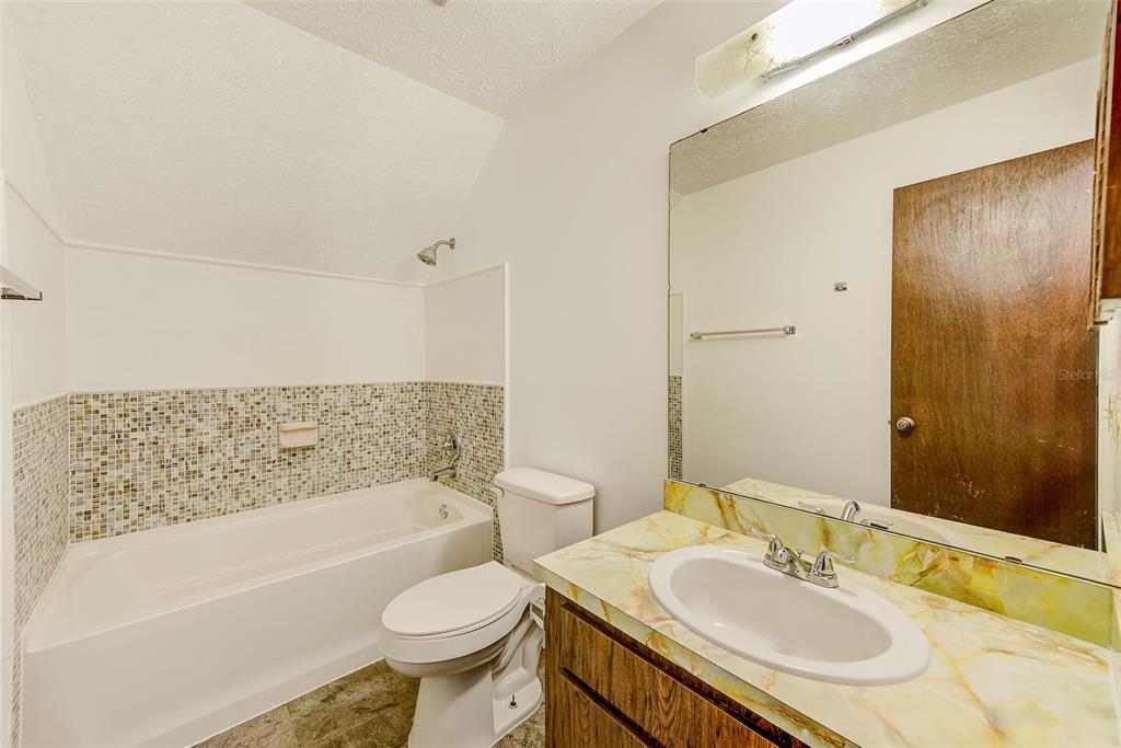 4707 East Temple Heights Road Tampa, FL 33617 - Photo 21 of 54 a bathroom with a granite countertop sink toilet and shower