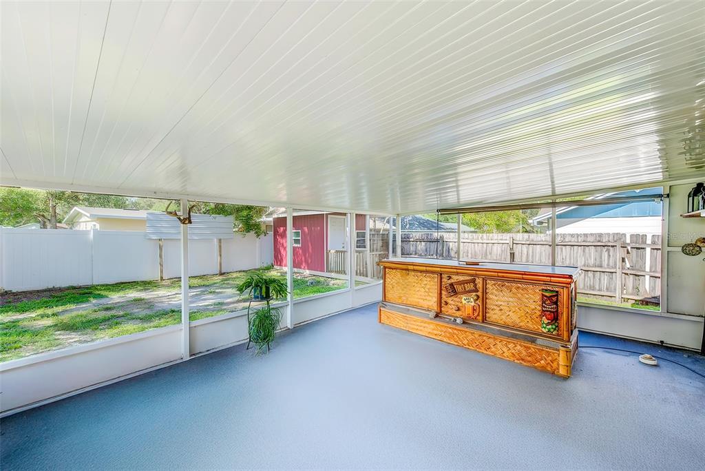 4707 East Temple Heights Road Tampa, FL 33617 - Photo 23 of 54 a blue bench sitting in the middle of a room