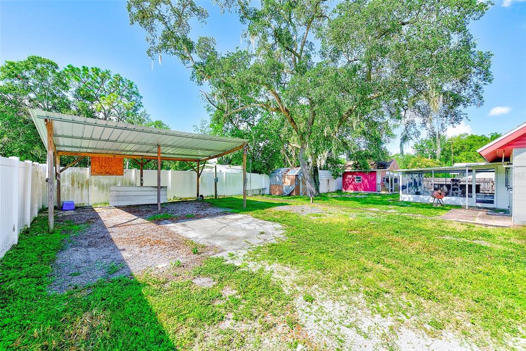 4707 East Temple Heights Road Tampa, FL 33617 - Photo 33 of 54 a view of backyard with table and chairs and potted plants