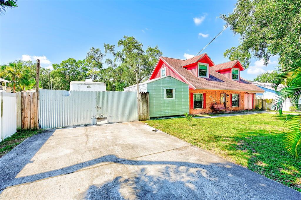 4707 East Temple Heights Road Tampa, FL 33617 - Photo 34 of 54 a front view of a house with a yard and garage