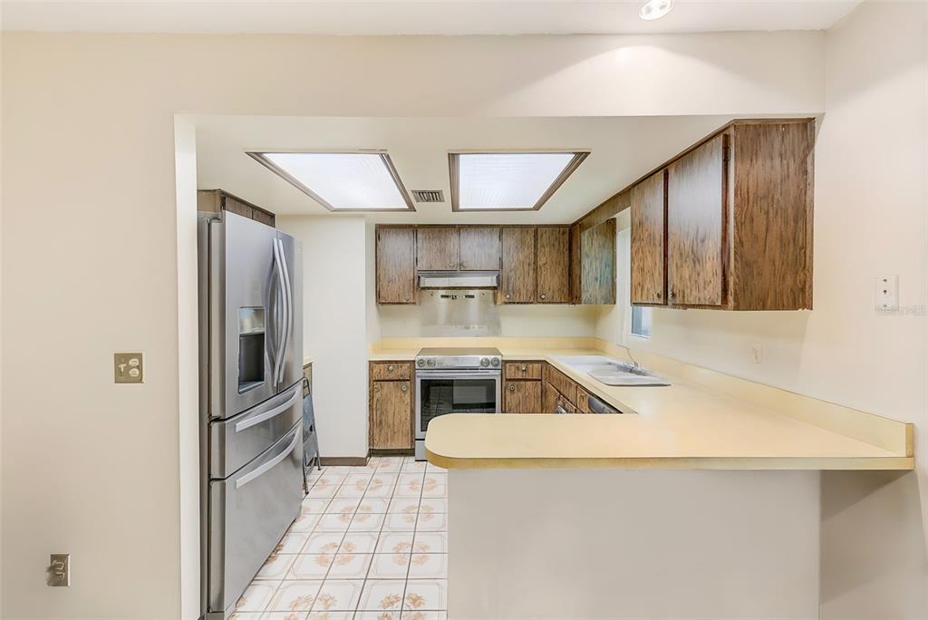4707 East Temple Heights Road Tampa, FL 33617 - Photo 9 of 54 a kitchen with a sink appliances and cabinets