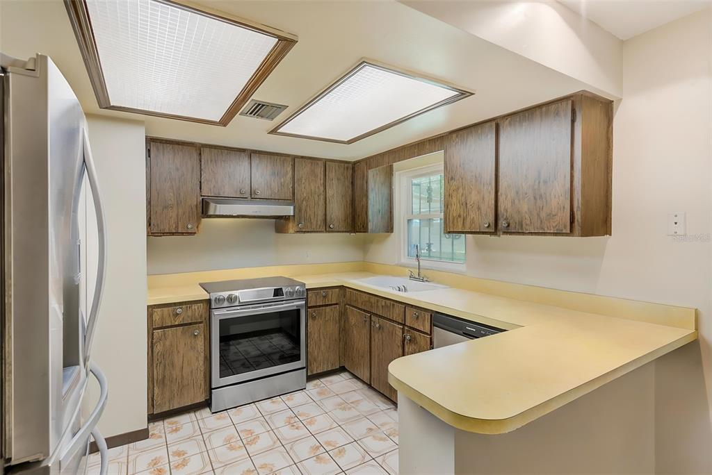 4707 East Temple Heights Road Tampa, FL 33617 - Photo 10 of 54 a kitchen with a sink appliances and cabinets