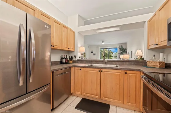 a kitchen with stainless steel appliances granite countertop a refrigerator sink and cabinets