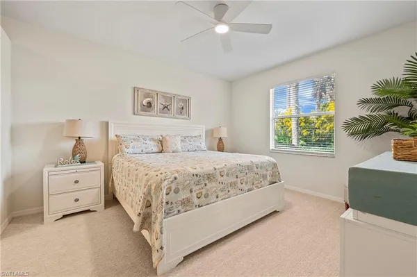 a spacious bedroom with a bed and a window