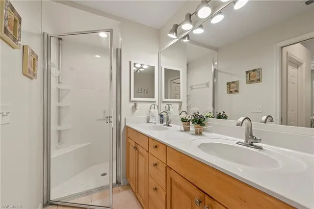 a bathroom with double vanity sink and a mirror